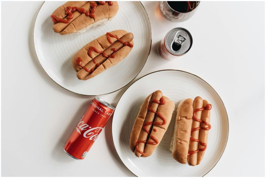 Delicious hot dogs with ketchup paired with Coca C