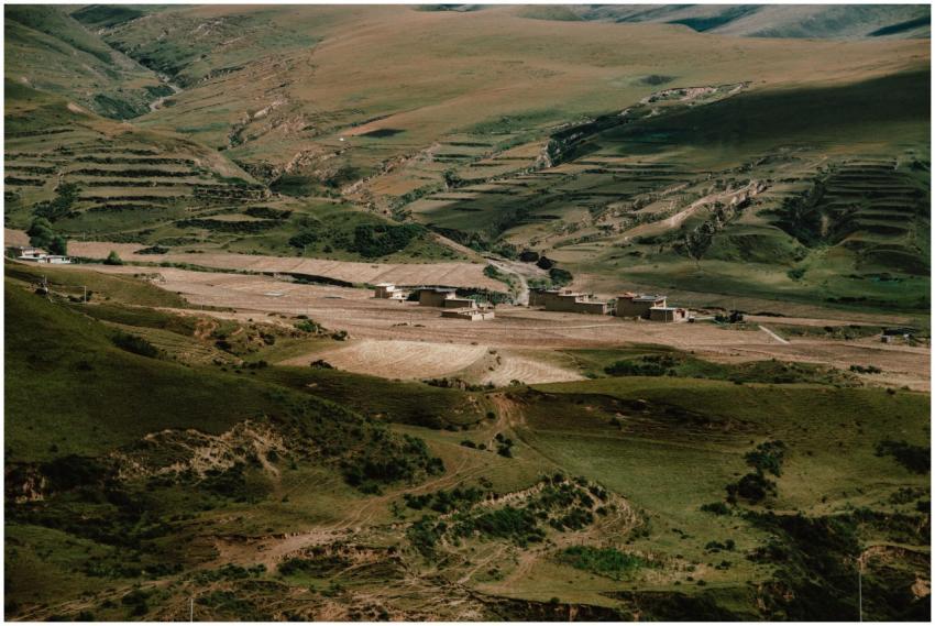 A stunning view of a rural valley with terraced fi