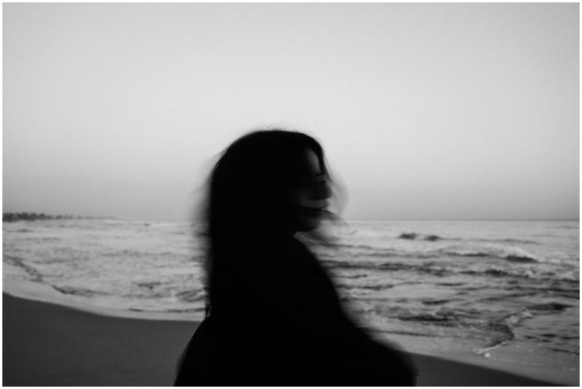 A silhouette of a woman with flowing hair on a pea