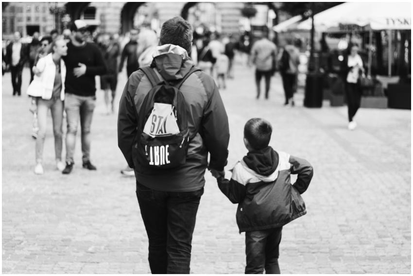 Father and son holding hands while walking through