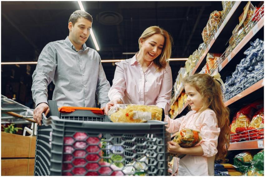 A joyful family of three shopping together in a su