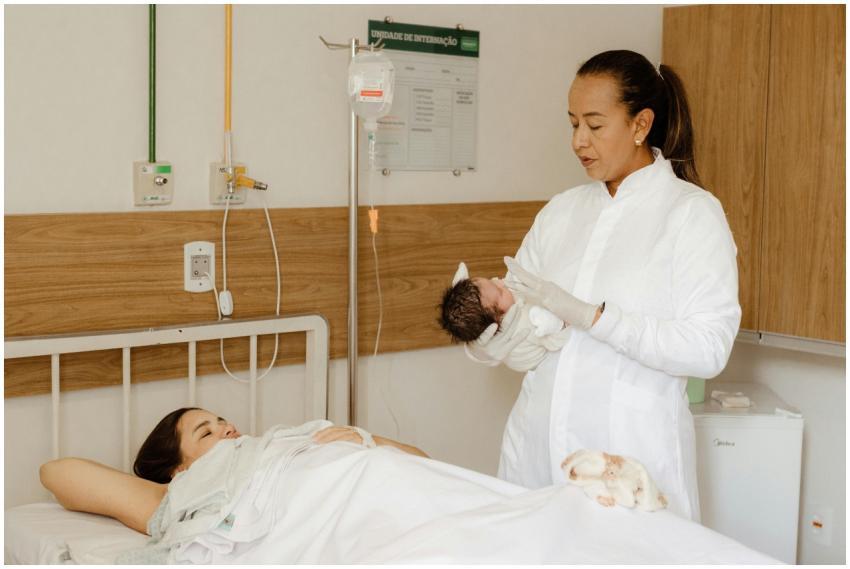New mother and newborn in hospital room with medic