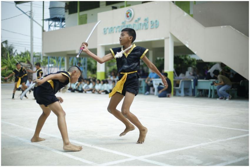 Boys practicing traditional Thai martial arts at a
