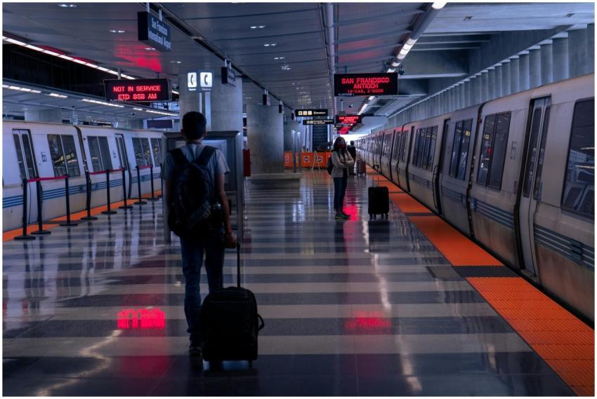 Travelers with luggage at a San Francisco metro st