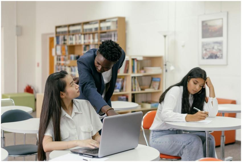 Students receiving guidance from a teacher in a we
