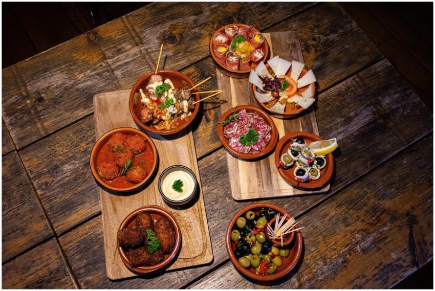 An inviting flat lay of diverse gourmet tapas on a