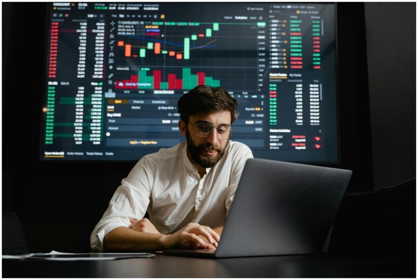 Male analyst studies cryptocurrency trends at a wo