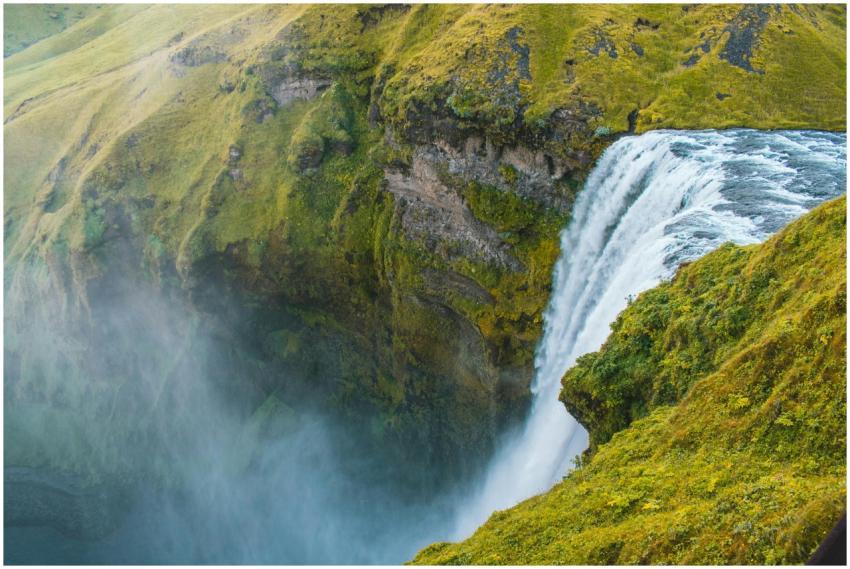 Stunning view of Skogafoss waterfall with lush gre