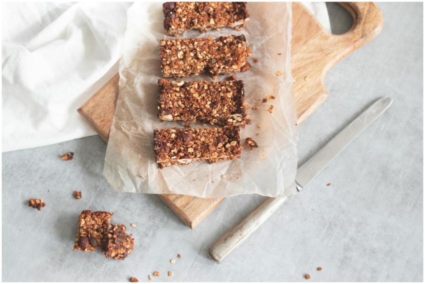 Delicious homemade granola bars on a wooden board,