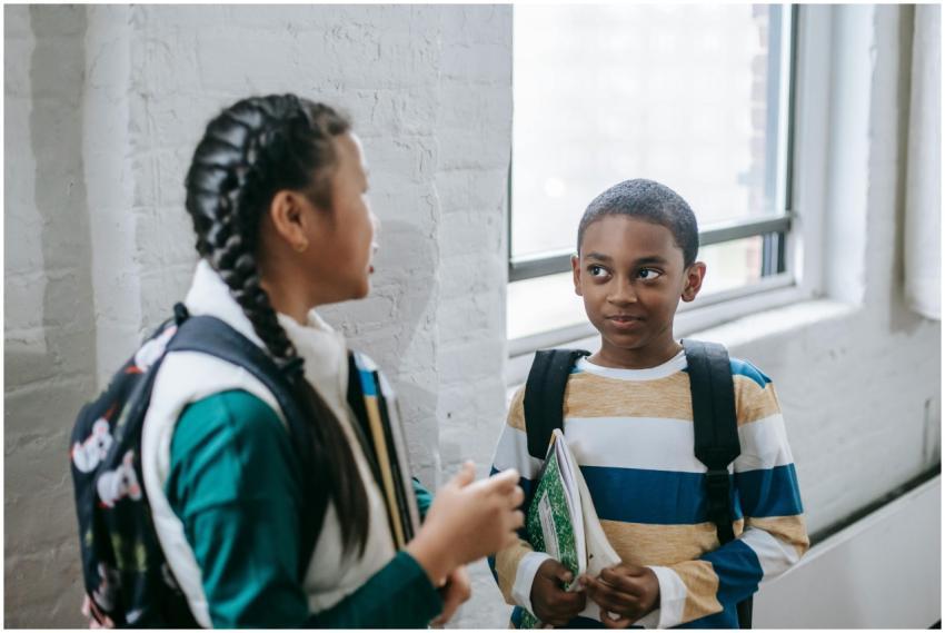 Content multiracial pupils with copybooks and back