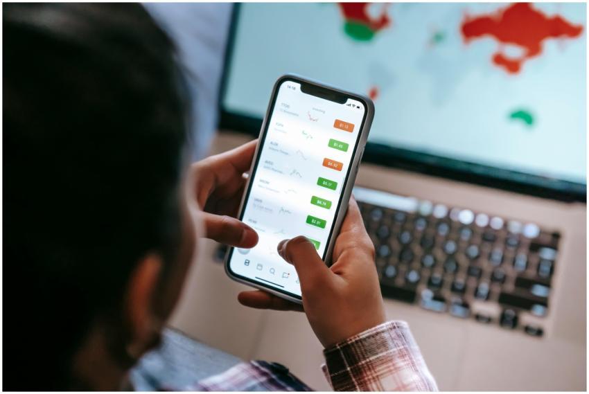 A person checks stock market graphs on a smartphon