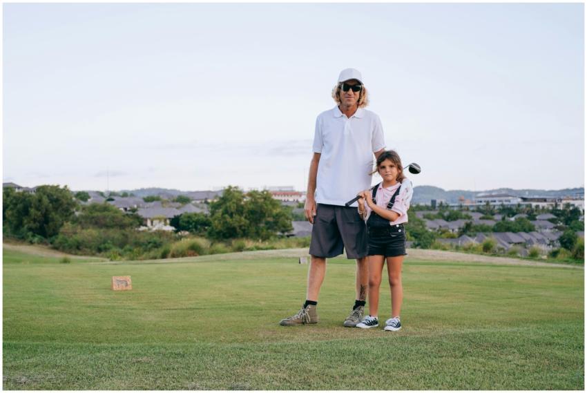 Father and daughter enjoying a day golfing togethe