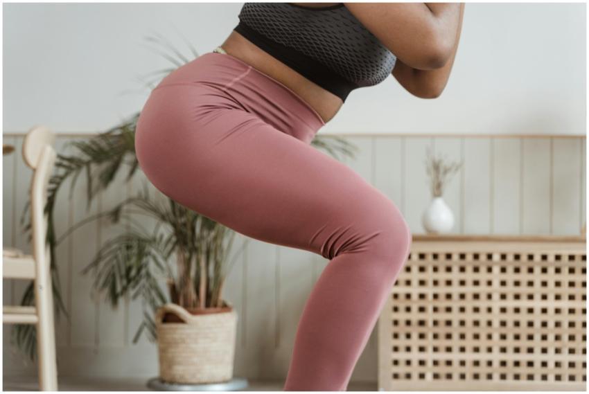 Close-up view of a woman squatting indoors wearing