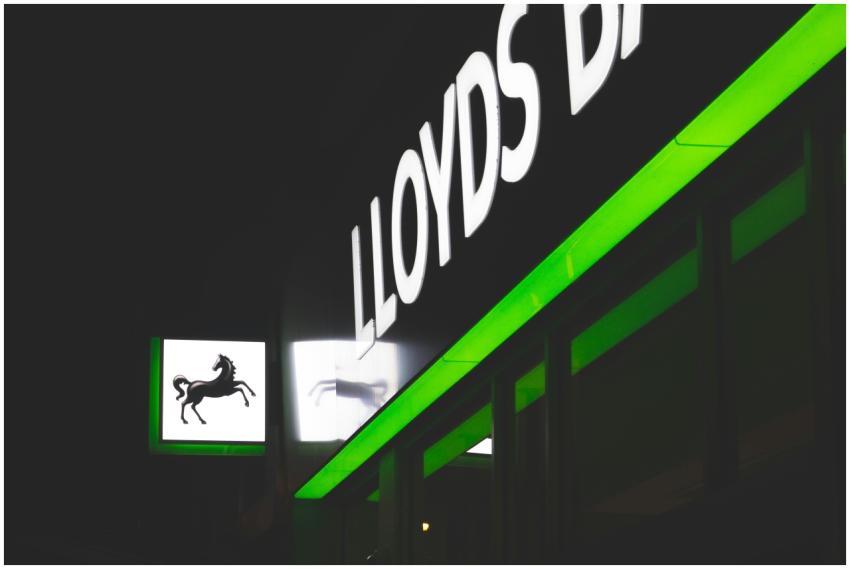 Bright green and white neon signs of Lloyds Bank a