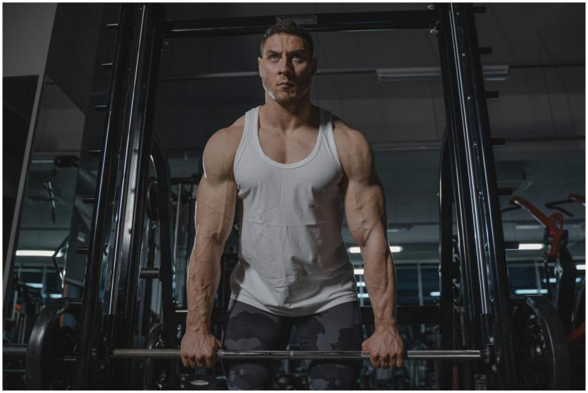 Male bodybuilder lifting weights during workout in