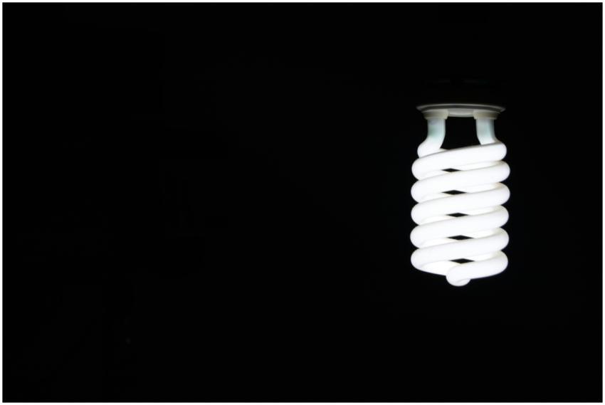 Bright spiral LED lightbulb against black backgrou