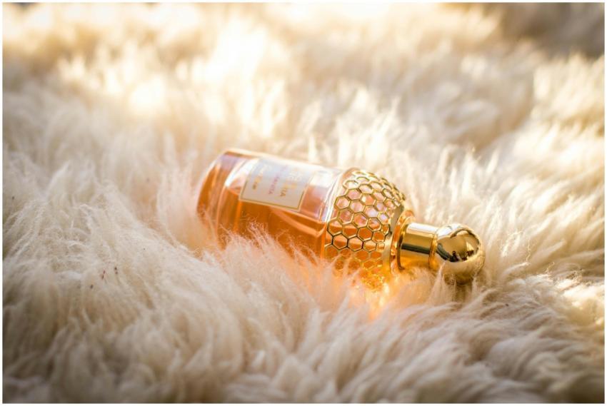 Elegant perfume bottle with gold details resting o