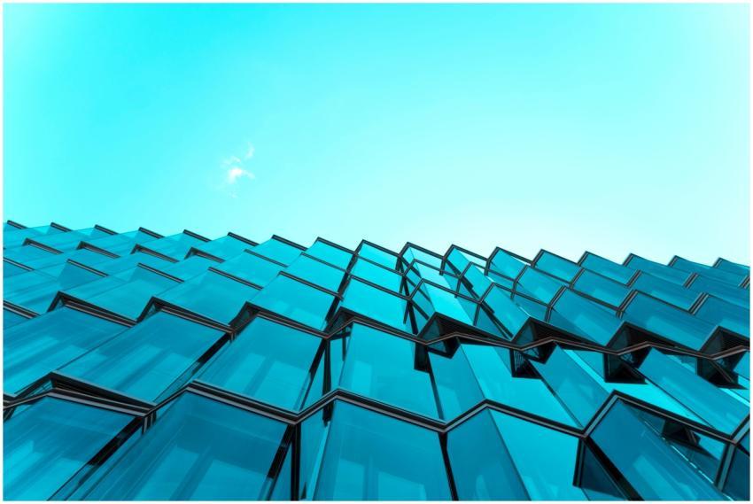 Low angle view of modern glass building facade wit