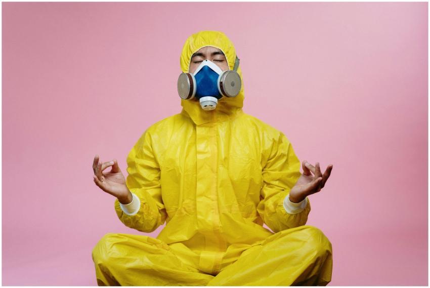 Man in protective suit and respirator practicing m