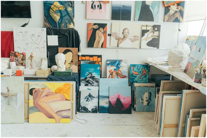 A vibrant art studio featuring diverse paintings,