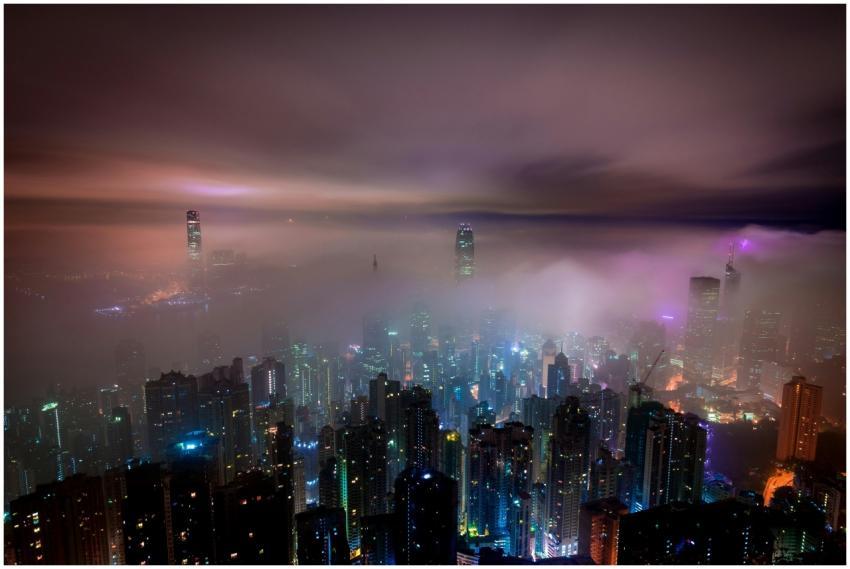 Captivating night view of fog-enshrouded skyscrape