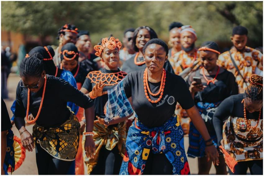 A group of people in traditional African attire pe