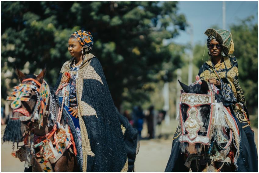 Women in vibrant traditional attire riding decorat