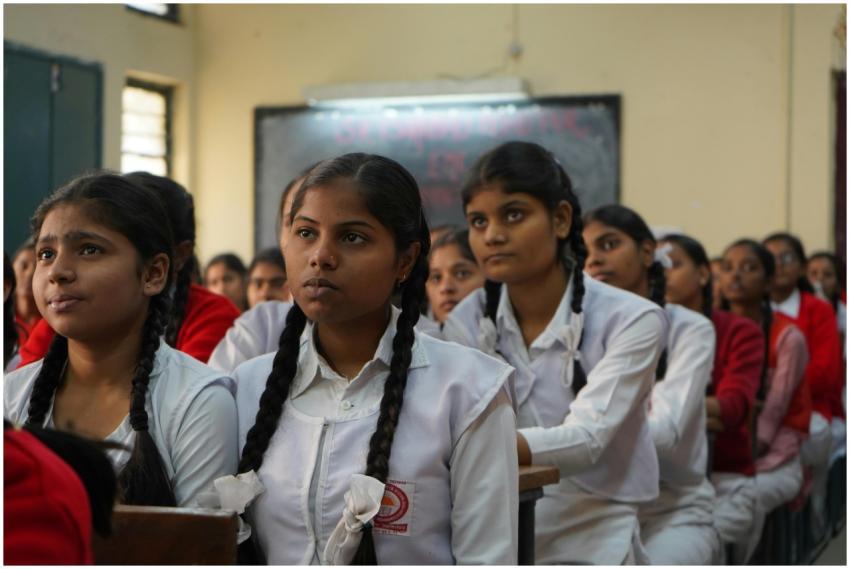 Group of Indian schoolgirls attentively listening