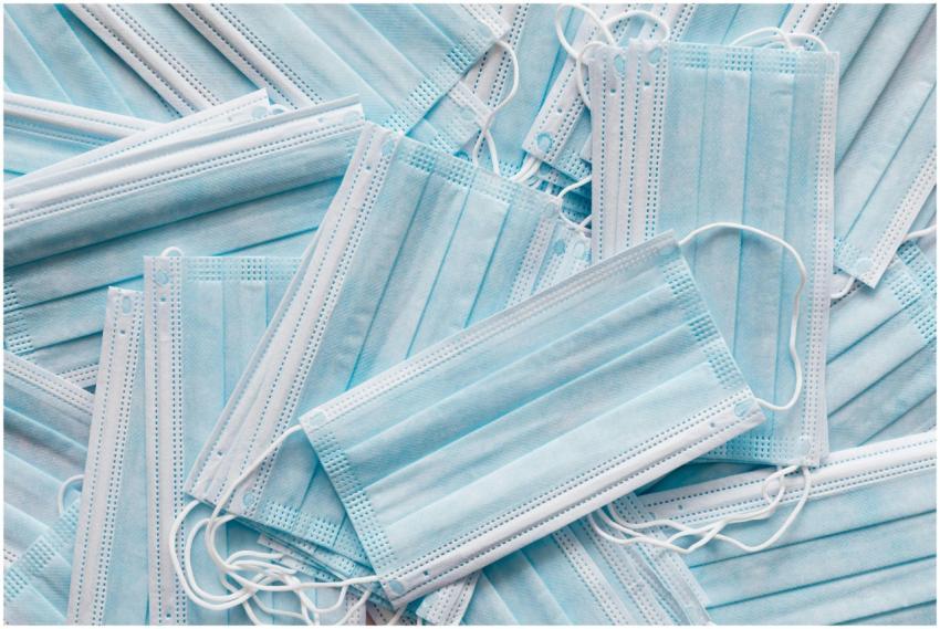 Top view of many clean single use light blue surgi