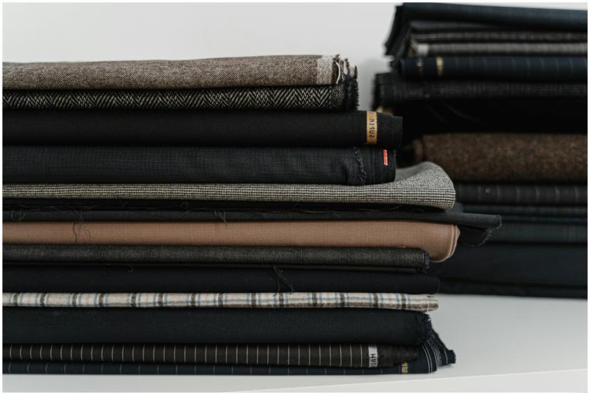 A neatly arranged pile of diverse fabrics, ideal f