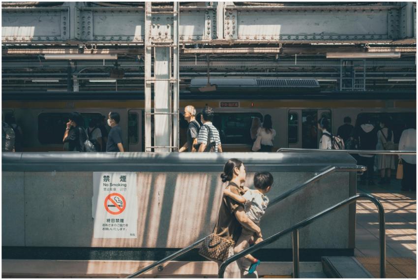 Commuters and a mother with child at a busy Tokyo