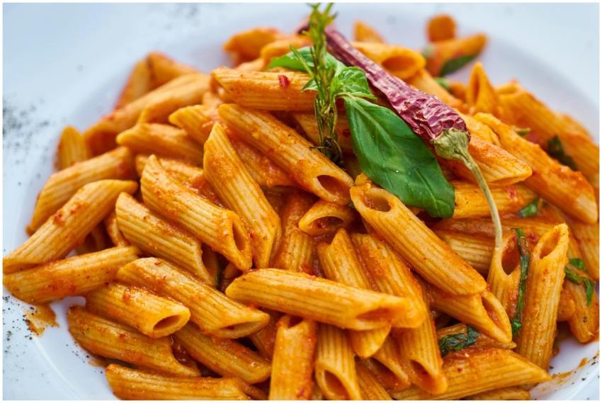 Delicious penne pasta with spicy red sauce, garnis