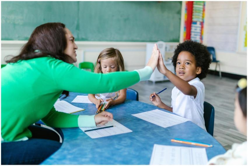 A teacher and students enjoying a high five during
