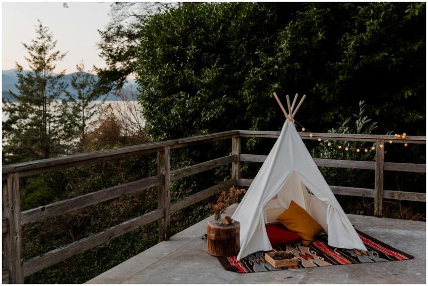 Boho styled tent with rug and pillows located on t