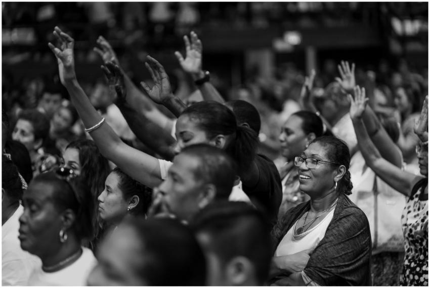 Black and white photo of a diverse crowd with rais