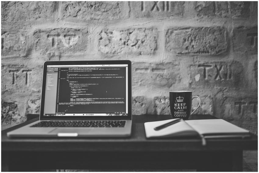 Black and white photo of a coding workspace with a