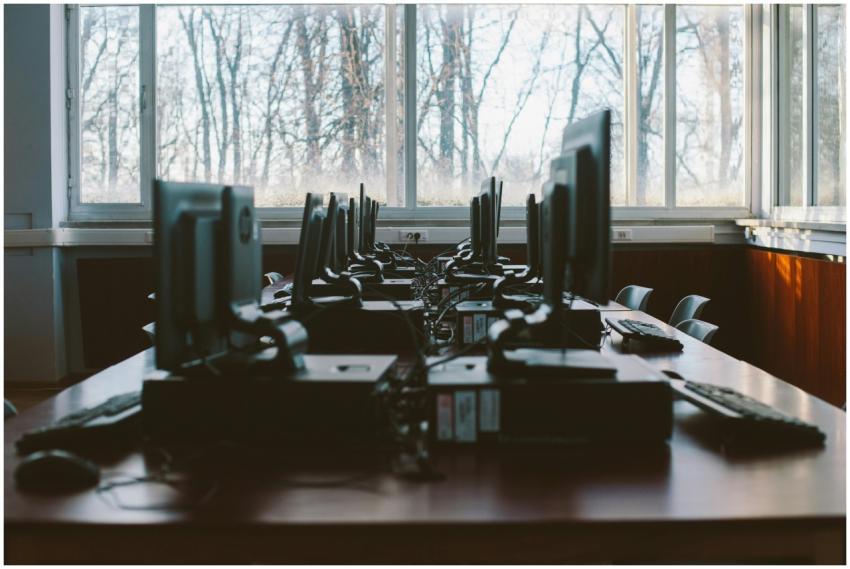 An empty computer lab with multiple workstations a