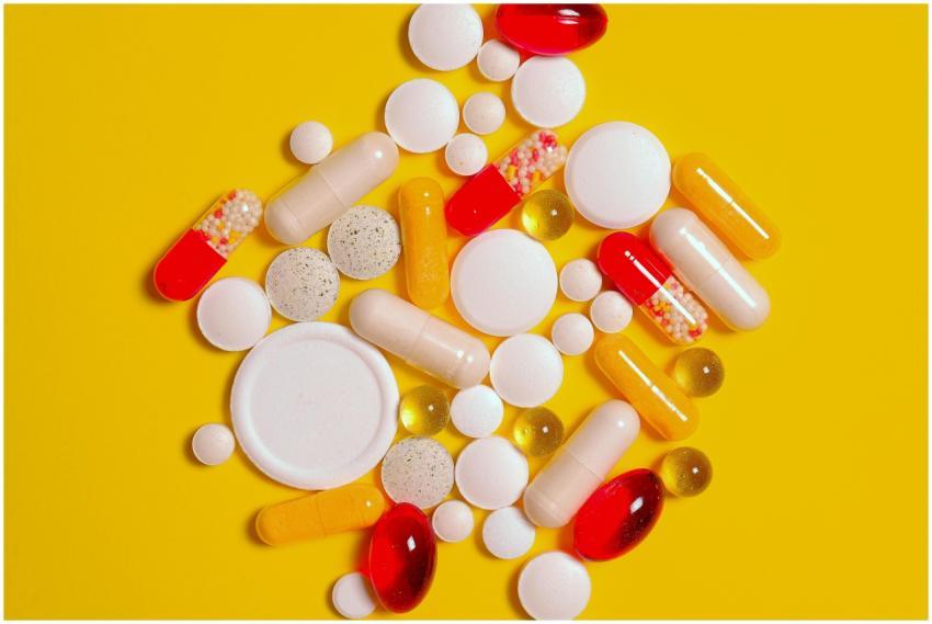 A vibrant assortment of pills and capsules on a br