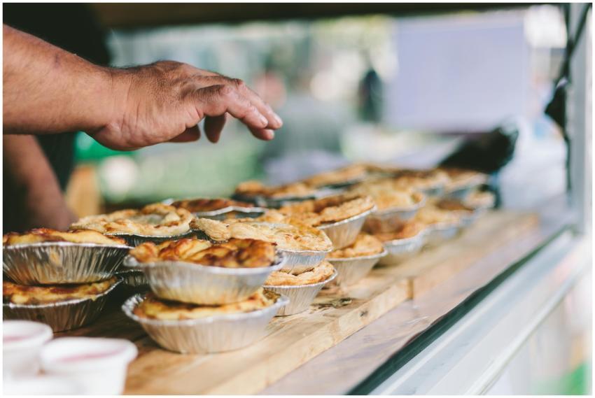 Hand reaching for delicious freshly baked pies at