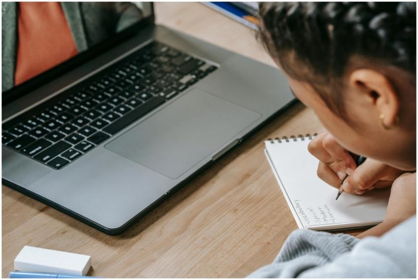 Child engaged in online education using a laptop a