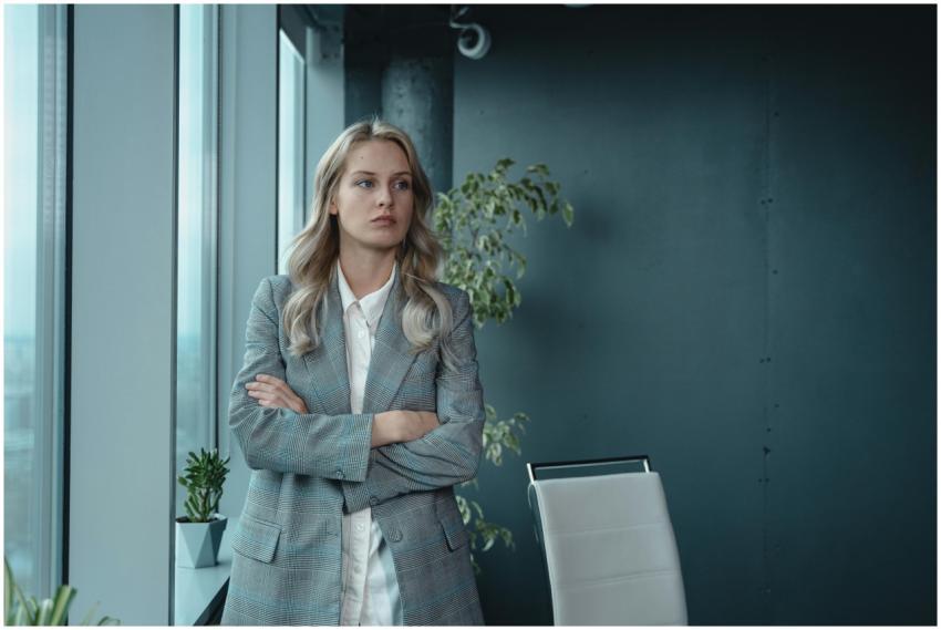 A professional businesswoman stands confidently in