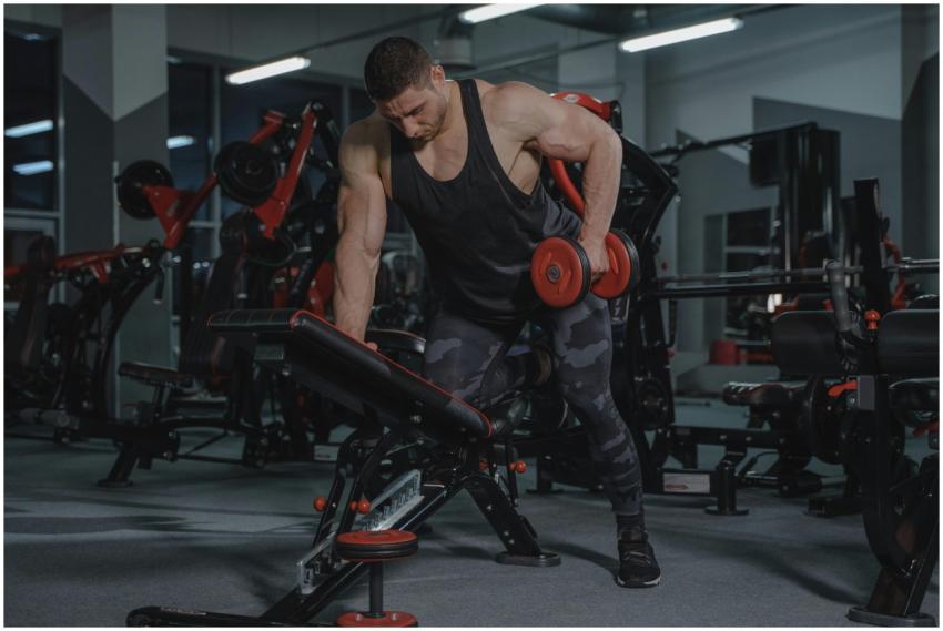 A strong, muscular man lifting dumbbells in a mode