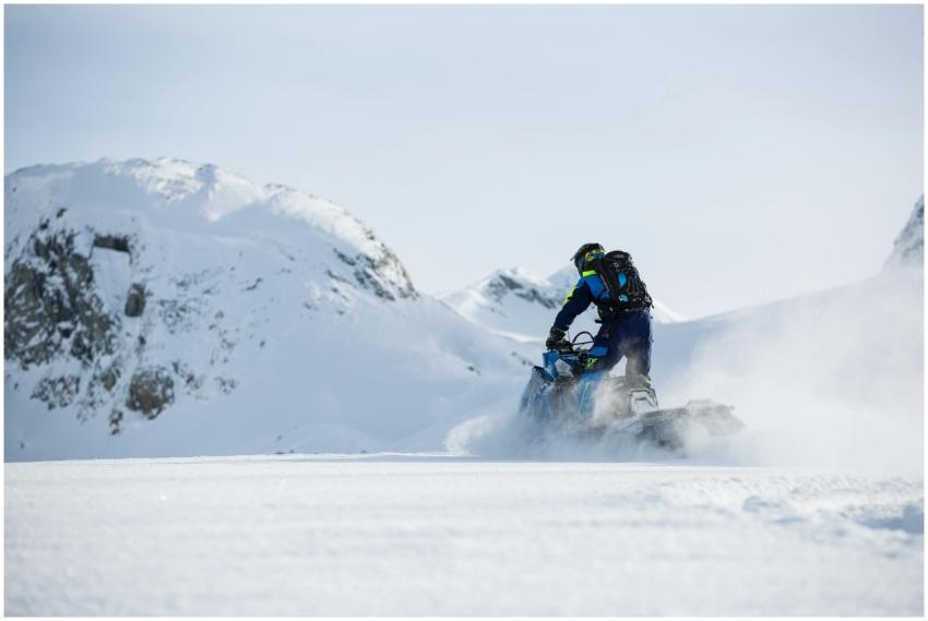 Exciting snowmobile ride across snow-covered mount