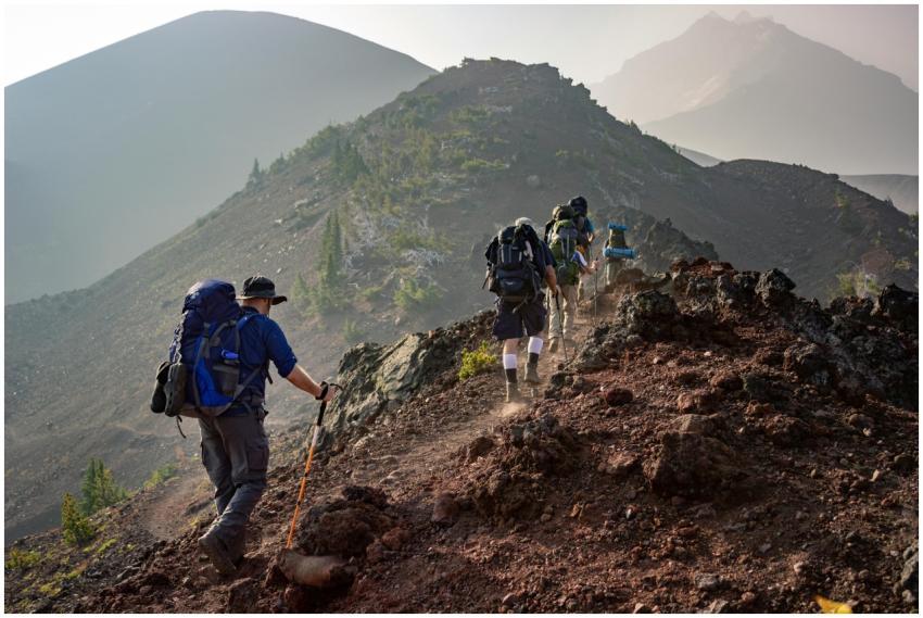 Group of hikers trekking on a rugged mountain trai
