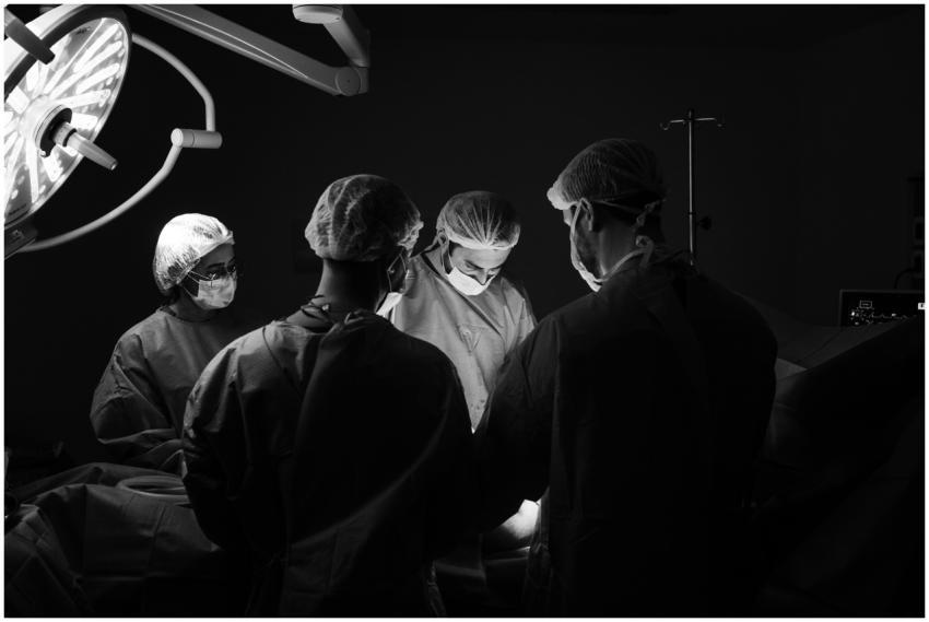 A group of surgeons in an operating room, focusing