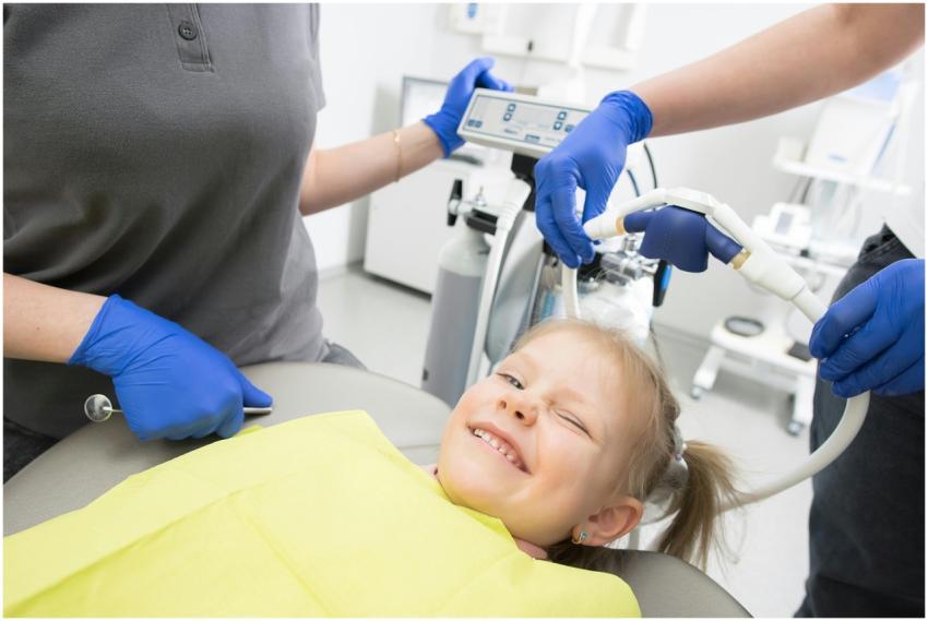 A cheerful child winks while sitting in a dental c