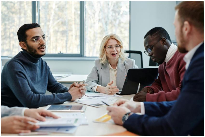 Group of professionals in a meeting discussing tea