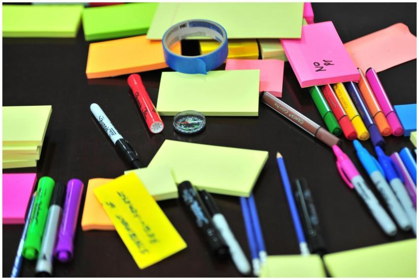 Colorful assortment of office supplies on a desk,