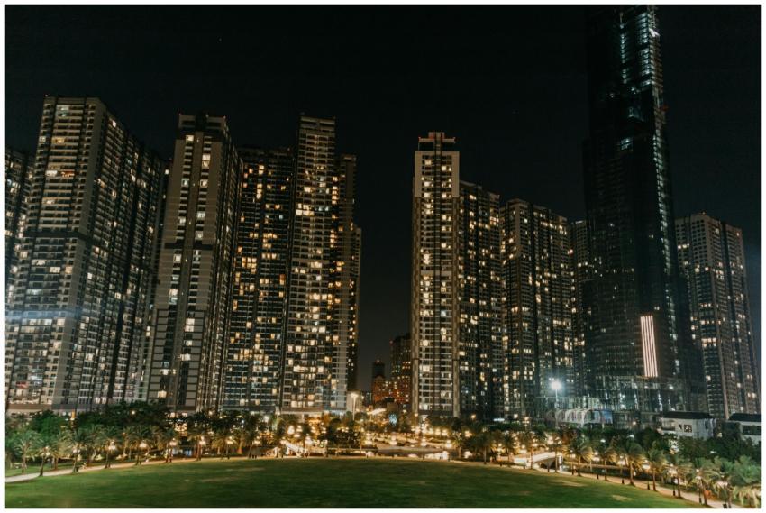 A vibrant night cityscape featuring modern skyscra