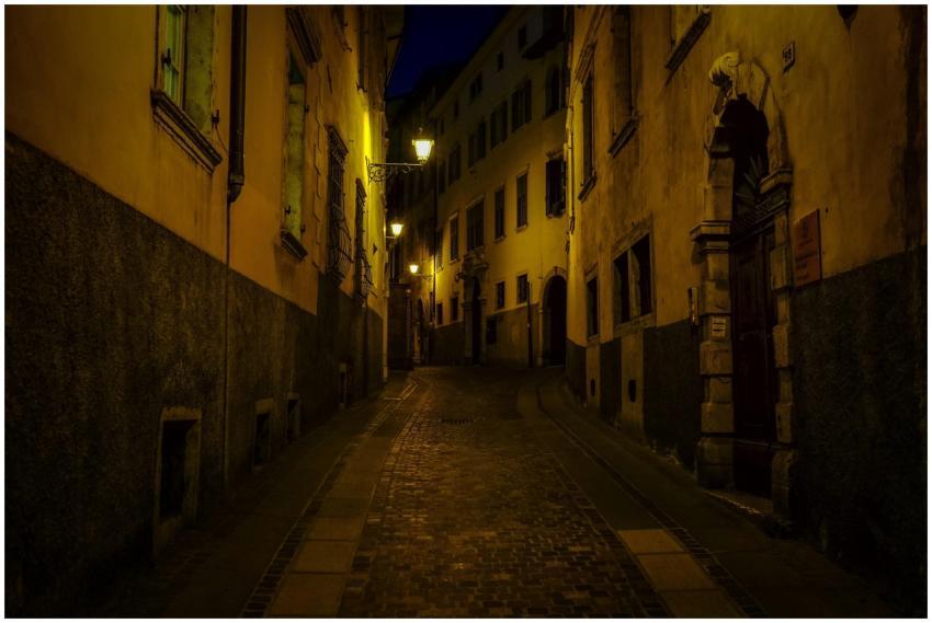 A dimly lit, narrow street in historic Rovereto, I